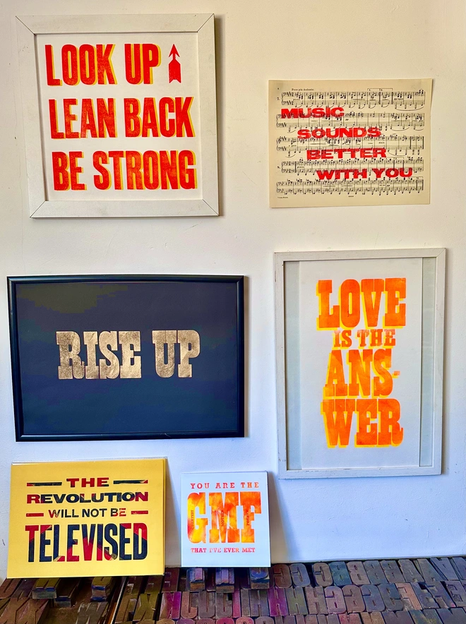 love is the answer letterpress print framed on wall with other posters