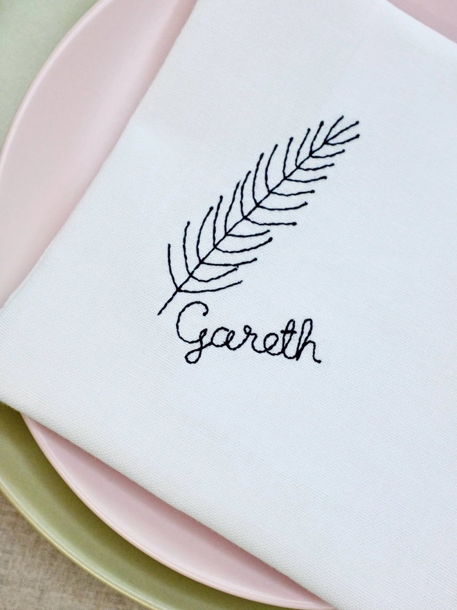 Fir embroidered napkin with custom name in black cursive text, cotton Christmas napkin