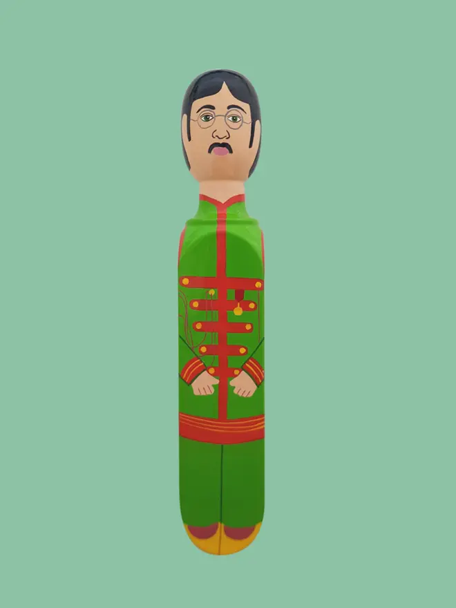 Wooden Door Stopper (Lenny), a colourful wooden door stop sitting on a white surface. 