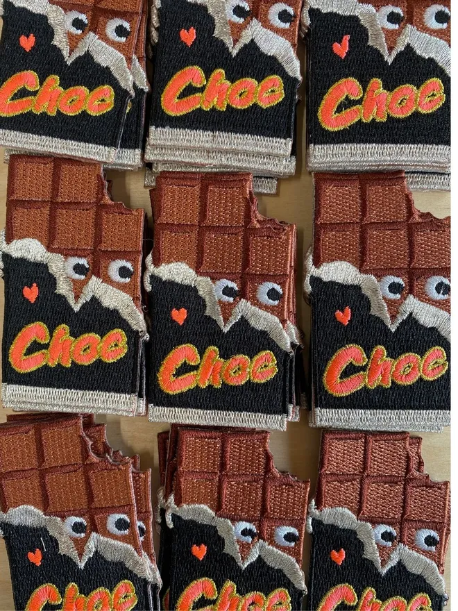 Chocolate bar iron on fabric patch with googly eyes.
