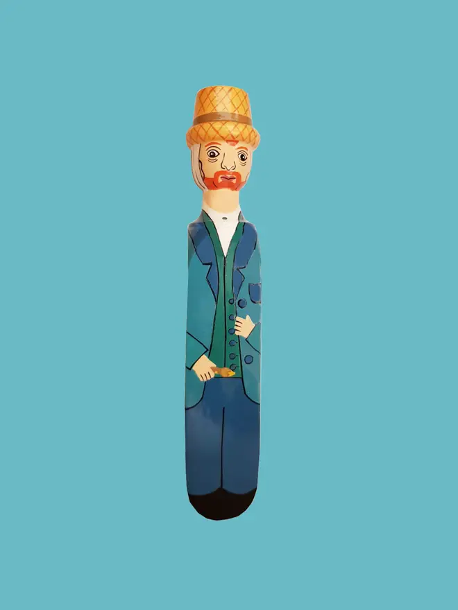 Wooden Door Stopper (Vinnie), a colourful wooden door stop sitting on a white surface. 