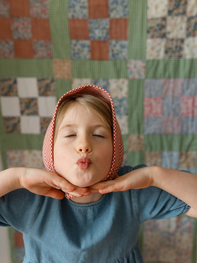 Girl with headscarf on blowing a kiss