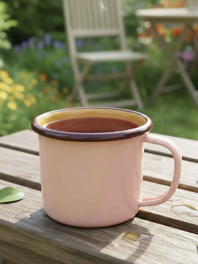 Enamel Mug, an enamel mug sitting on a wooden table outside. 