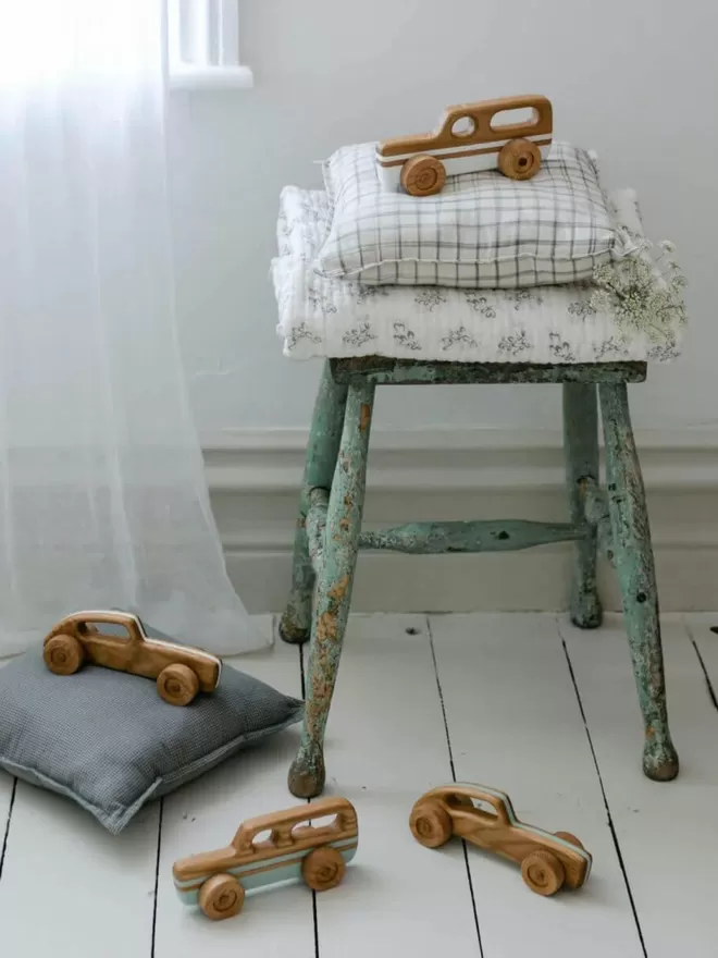 4 of the wooden toy cars in various different angles 