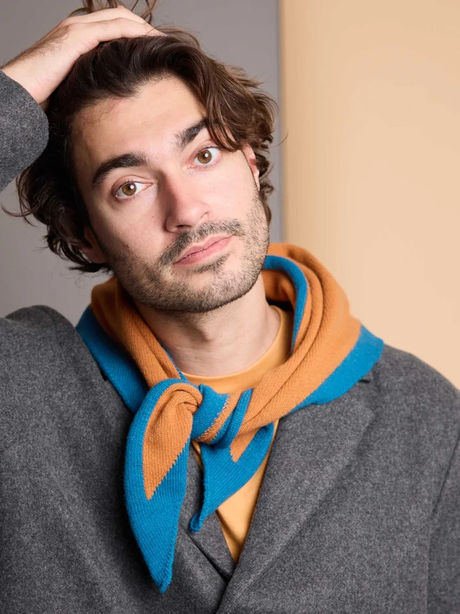 man wearing rust and teal wool neckerchief