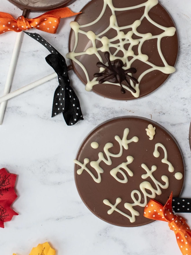 Spiderweb and trick or treat chocolate lollipops