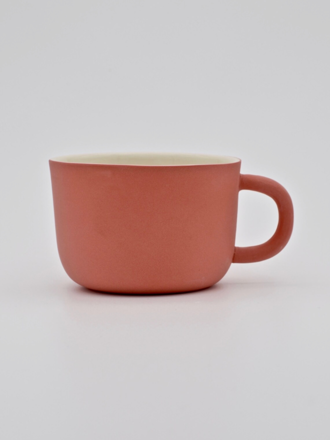 Handmade Porcelain Coffee Cup. A pink-red coffee cup.