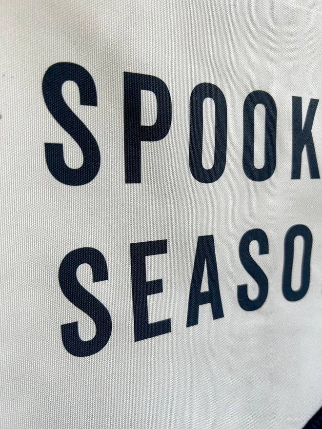 Printed black fabric Spooky Season Halloween Banner with tassel ghosts and a black trim
