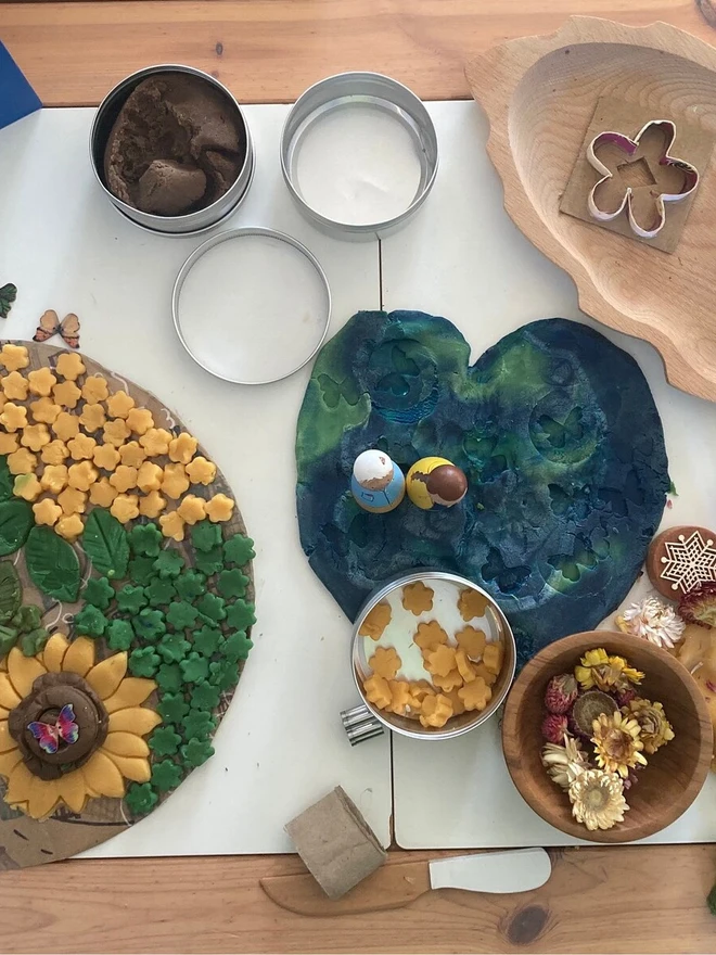 earth sensory play dough. a craft set up with earth blue and green play dough.