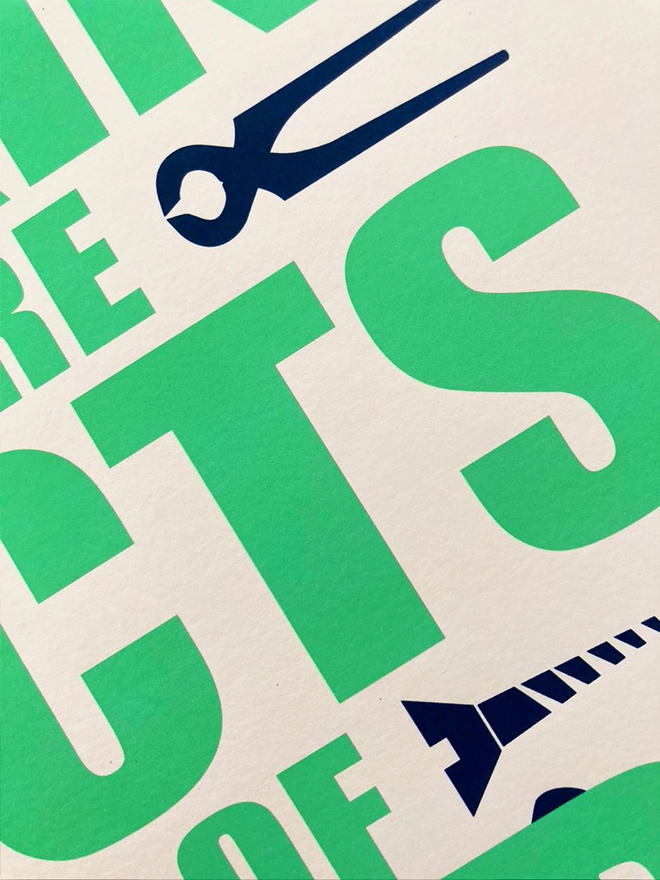 Detail from a green and blue typographic print. The Corita Kent quote reads "Doing and making are acts f hope." Navy blue tools are placed around the green text.