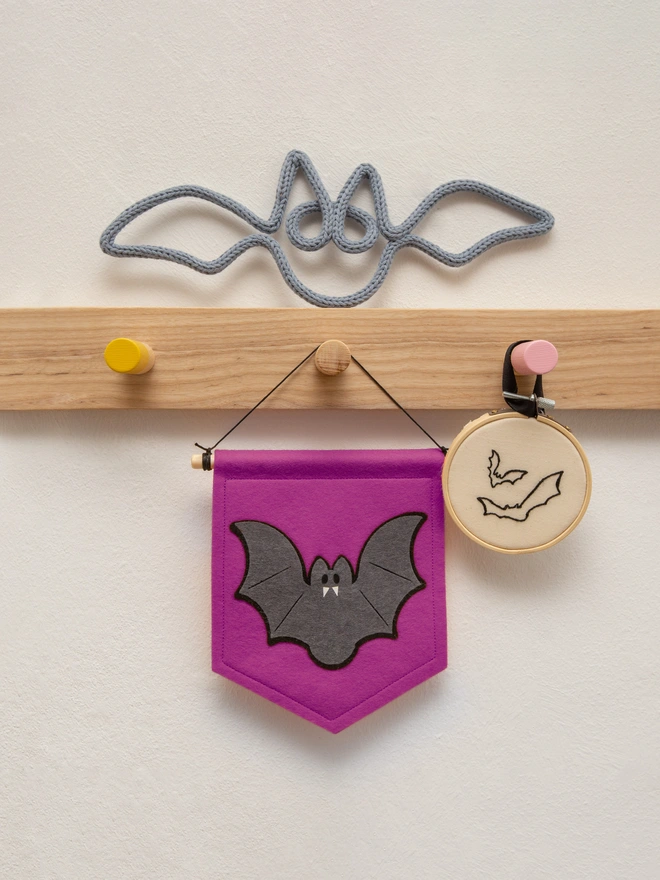 cute halloween bat banner made from felt. The banner is thistle purple and had a dark grey and black bat on it.