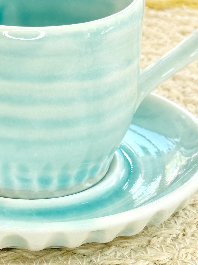 Detail of turquoise espresso cup and saucer fluting