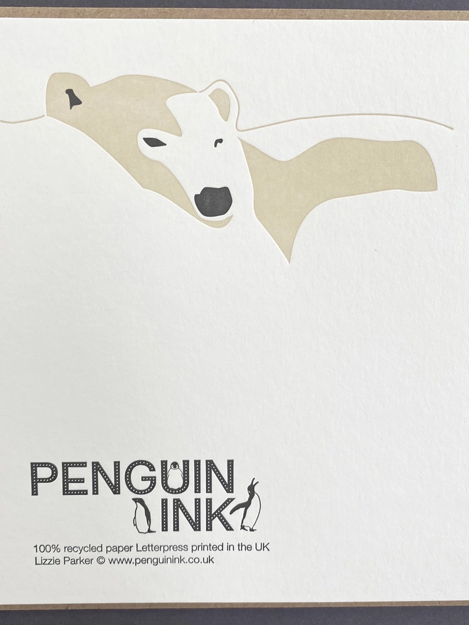 Sleepy polar bear on the back of the big card with the Penguin Ink logo