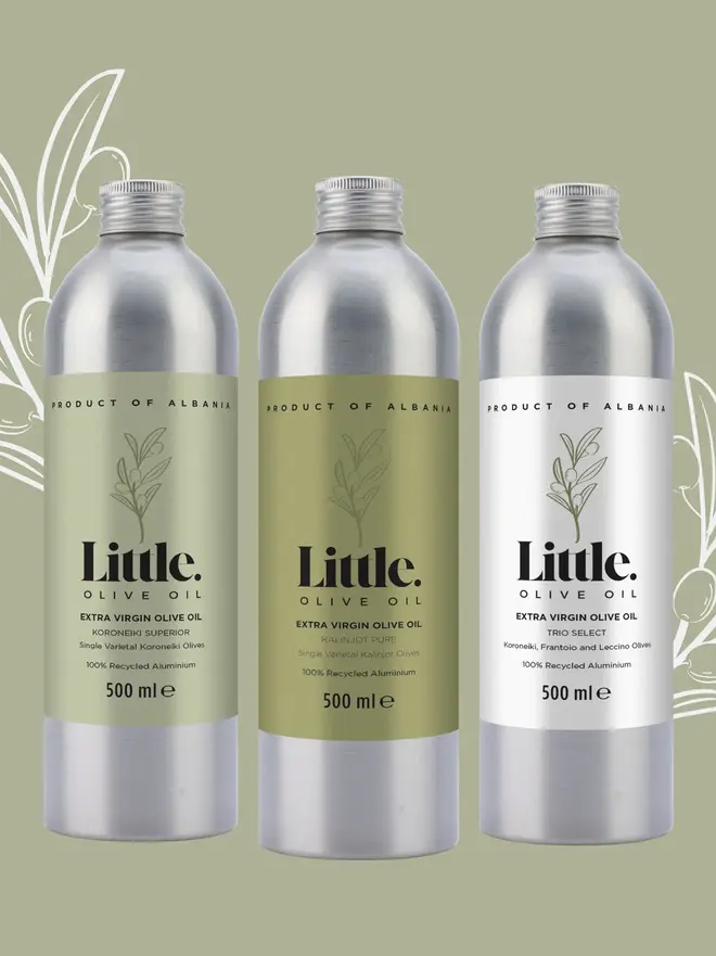 three stainless steel bottles of olive oil with green and white labels