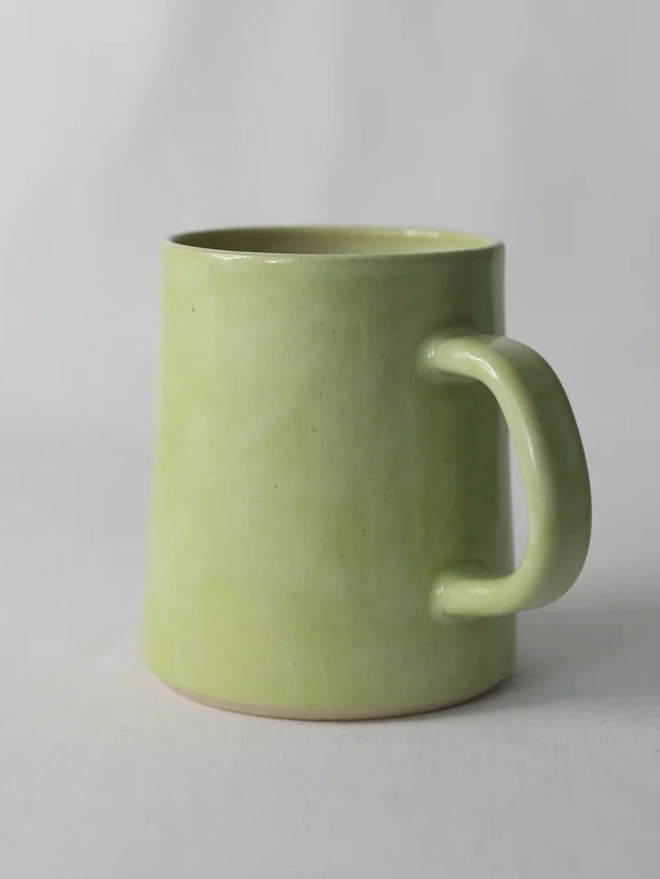 Ceramic Pint Mug, a colourful ceramic mug sitting on a white surface against a plain backdrop. 
