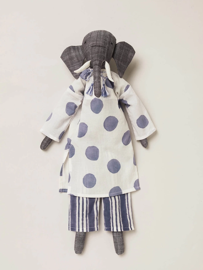 Grey elephant stuffed doll wearing navy and white stripe trousers and a white kaftan with oversized navy spots