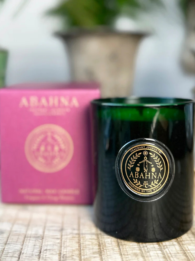 frangipani and orange blossom natural wax candle. a green glass container candle and pink box.