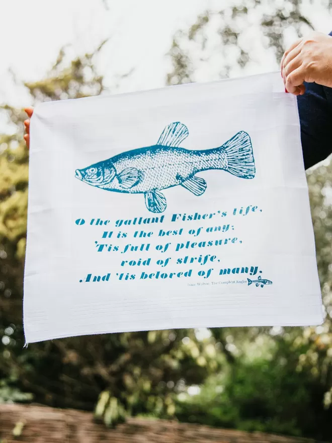 A Mr.PS Fisher Handkerchief held in strong sunshine in a leafy garden