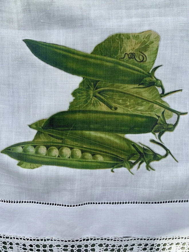 A vintage cotton linen cloth printed with vintage images of pea pods