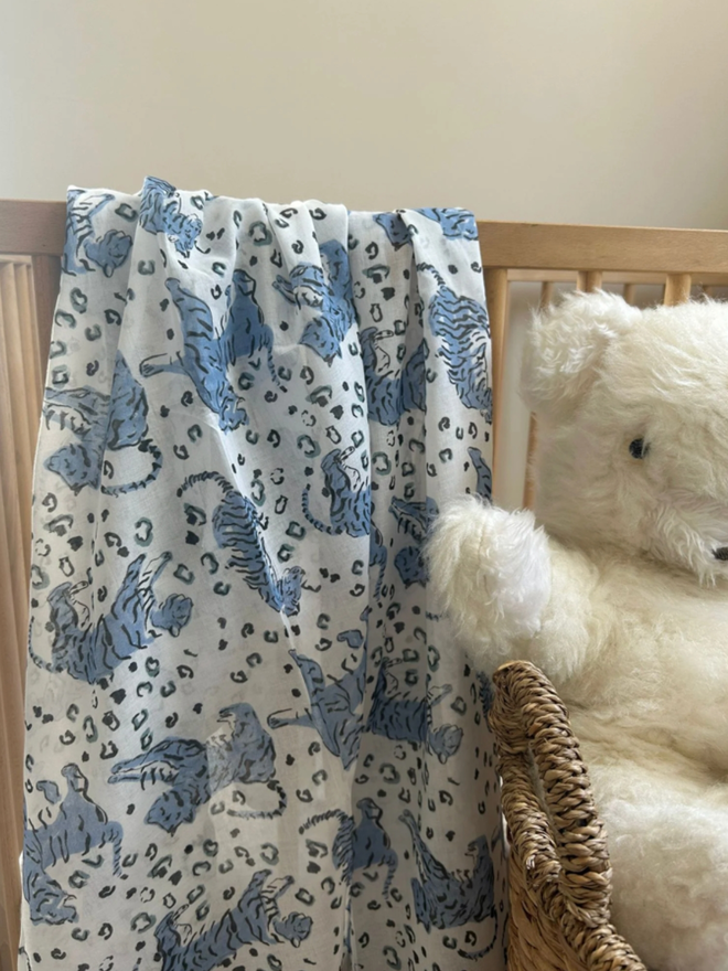 Whimsical Tigers Muslin. A muslin on a chair with a blue tiger pattern.