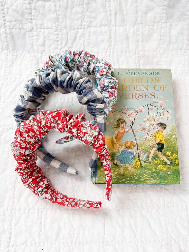 All the ruffled hairbands made from Liberty fabric on a vintage book