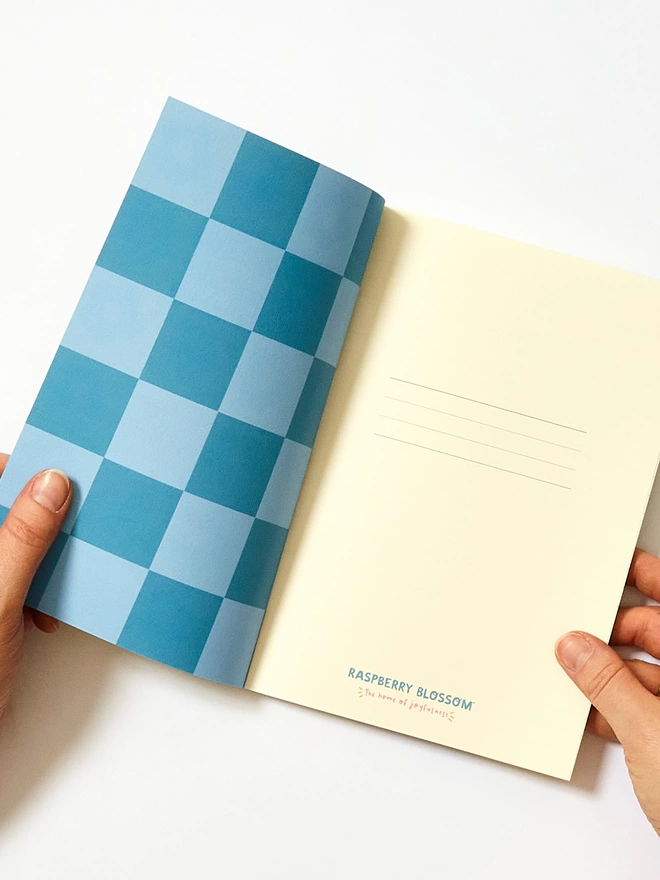 The inside cover has a blue and light blue check design