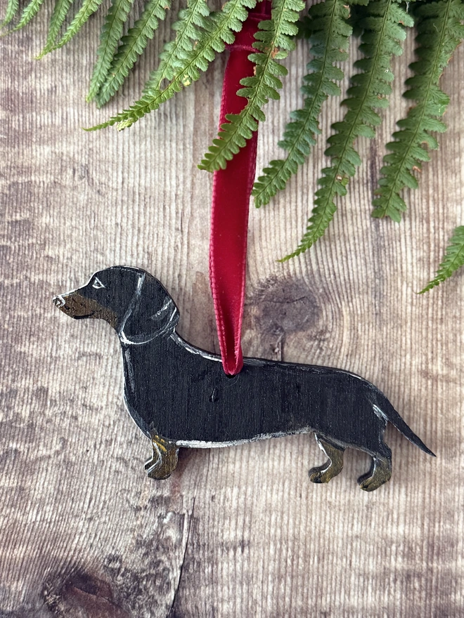 Black and Tan Smooth - haired Wooden dachshund Christmas Decoration hung with red velvet ribbon 