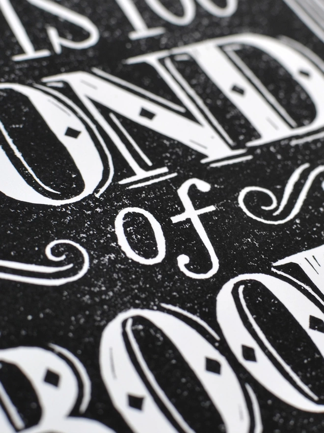 detail of black lino cut print lettering