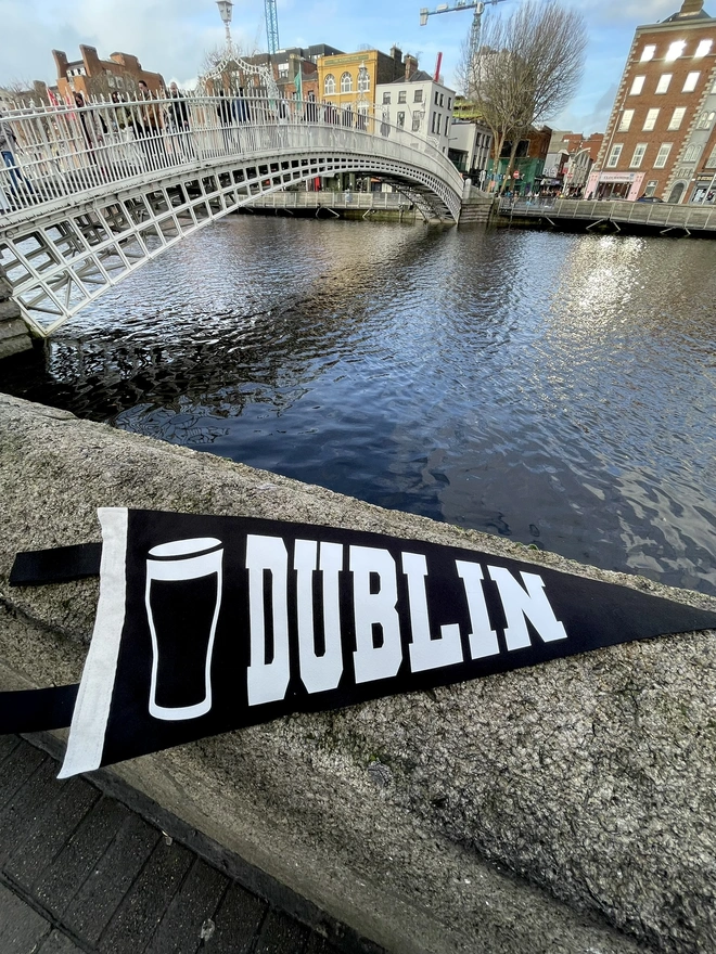 a felt pennant flag black and white, it has the word DUBLIN written in the varsity style and a pint of Guiness next to it