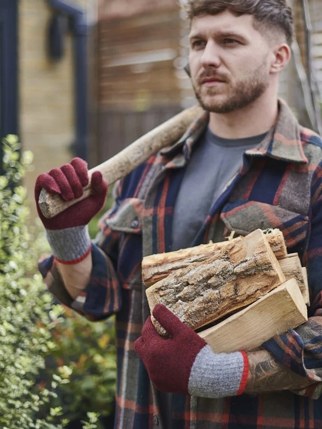 Block Lambswool Gloves, a pair of colourful gloves worn by a man having just chopped wood. 