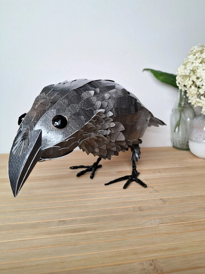 face view of a raven paper sculpture