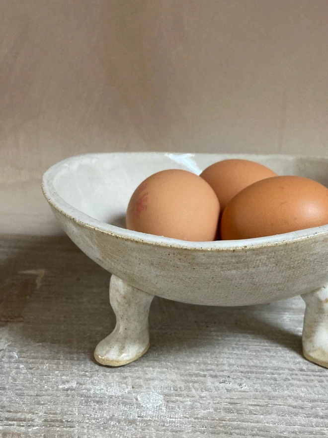 close up stoneware bowl with legs