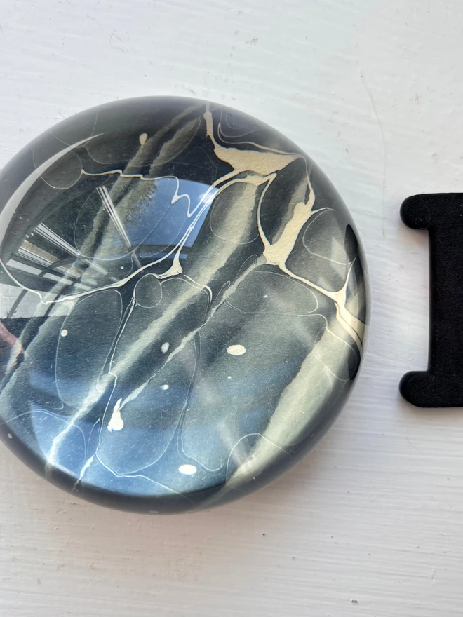 Small Paperweight. A paperweight in I