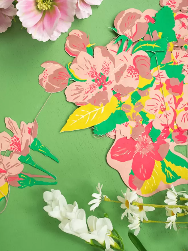 Blossom florals with white and pink flowers, placed on top of a bright green background