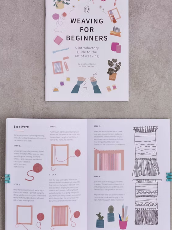 large weaving kit. a weaving instruction manual open on a plain background to show an example page.