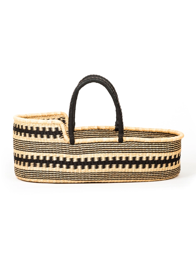 black and natural woven moses basket with leather wrapped handles