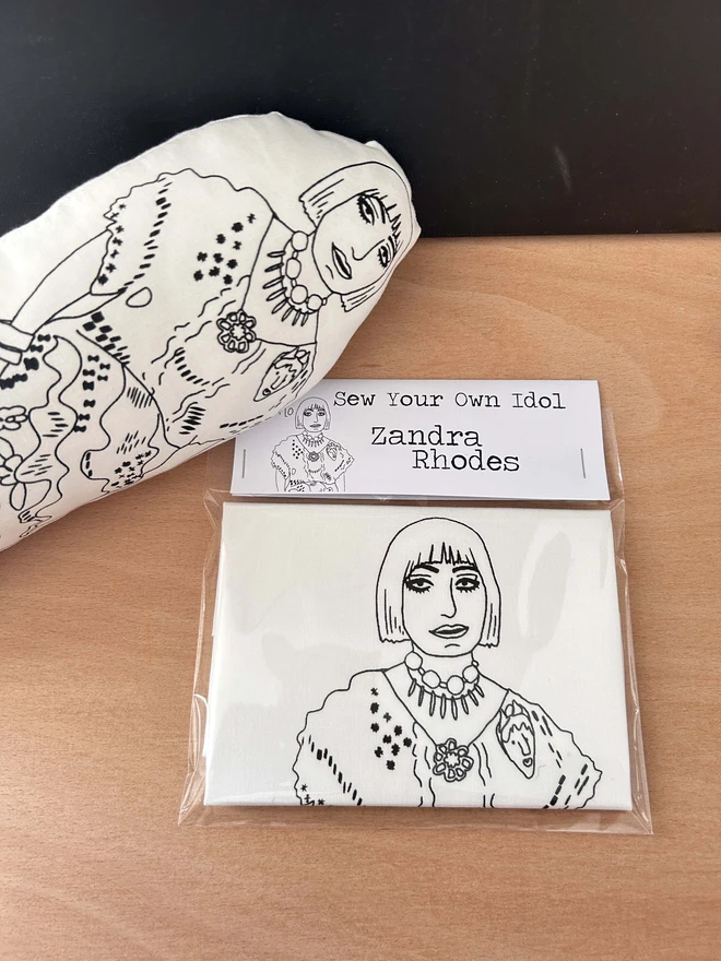 A craft kit to Sew Your Own Idol which contains a black and white fabric cushion featuring an illustration of Zandra Rhodes.