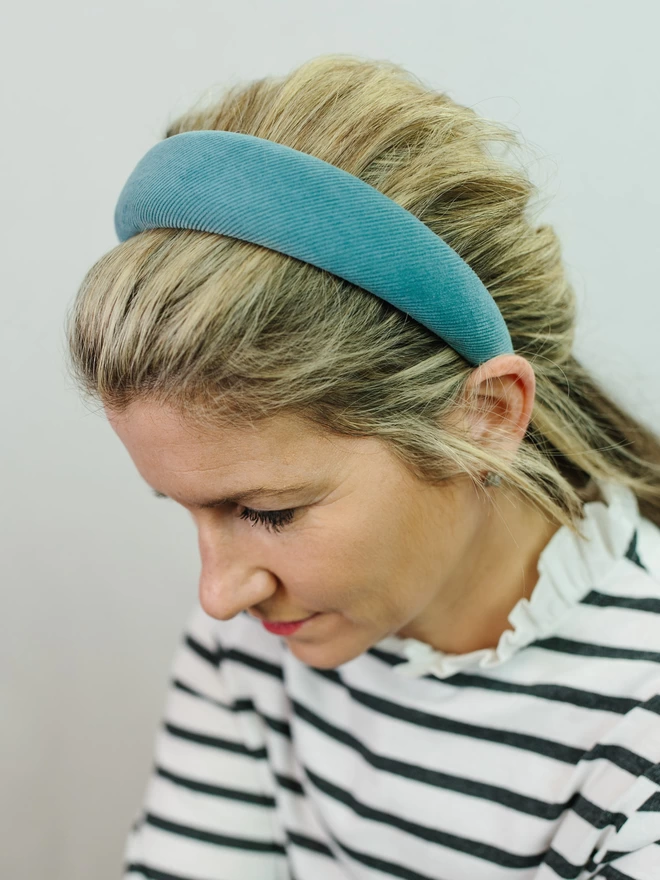 model with blonde hair wearing padded corduroy blue hairband