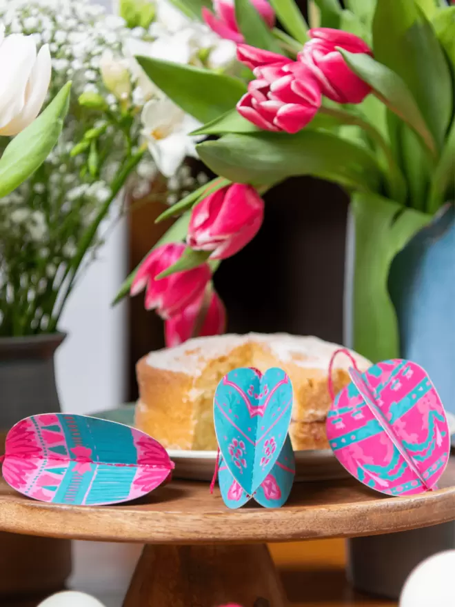 Close-up, detailed shot: pink and blue easter egg sitting on table 