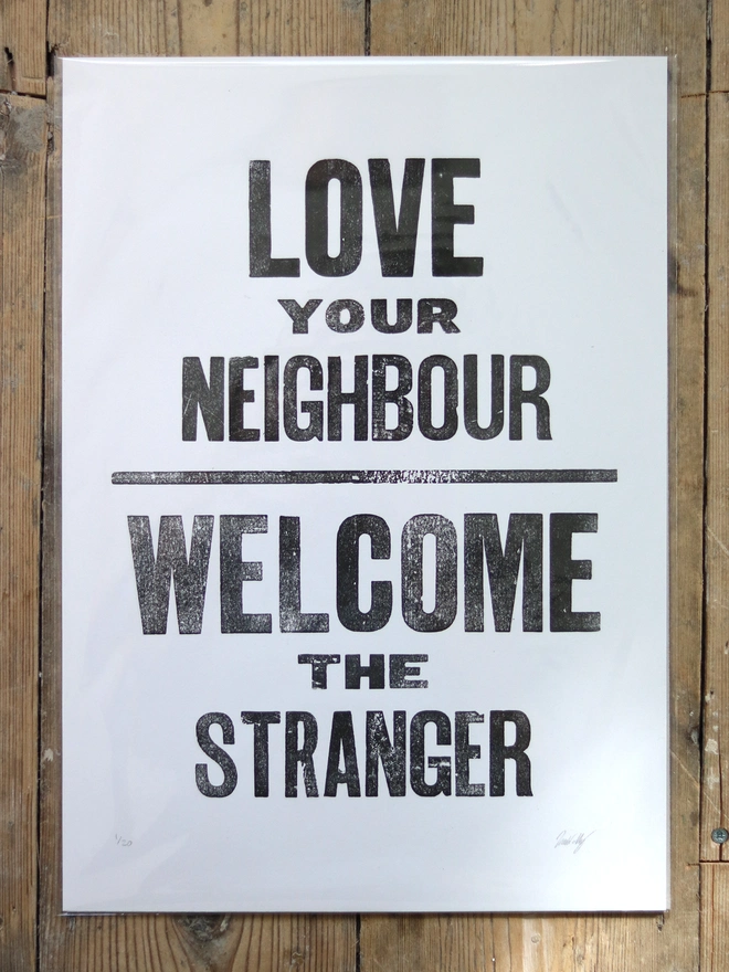Original letterpress poster featuring the words 'Love your neighbour, welcome the stranger'