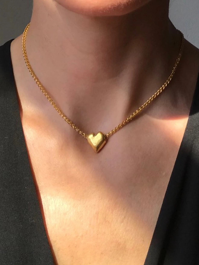 a gleaming heart pendant strung on a modern chunky chain