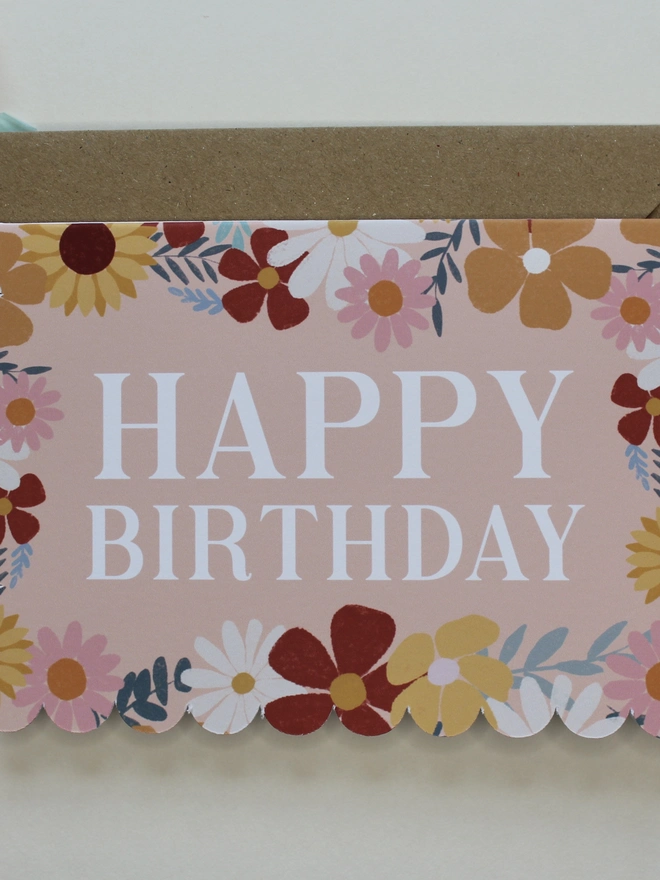 floral happy birthday card. scallop edged birthday card with illustrated flowers.