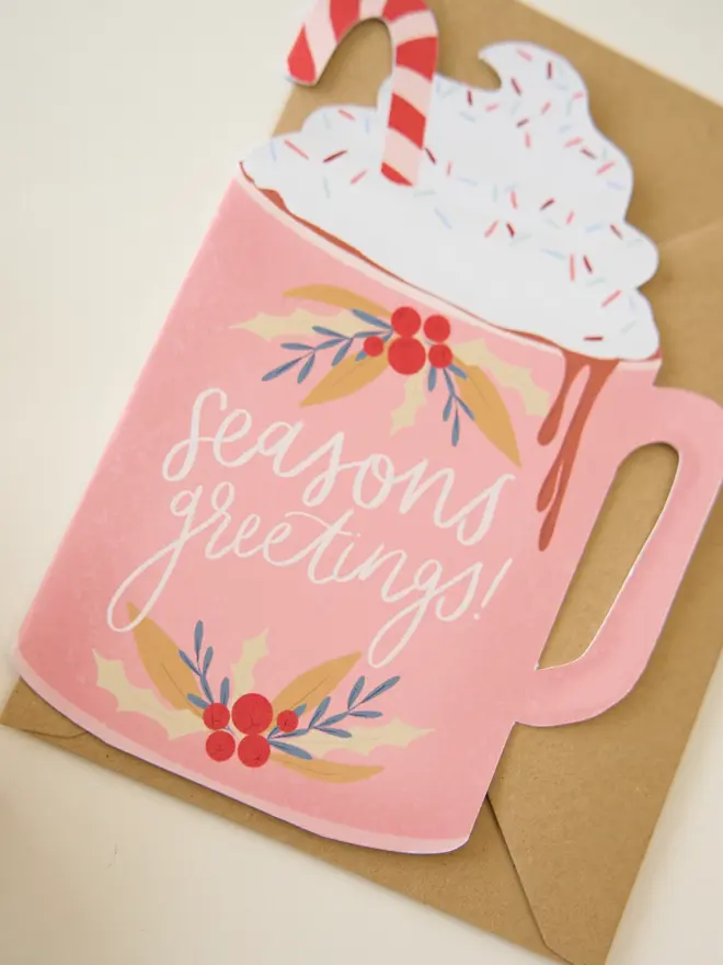 Seasons greetings illustrated pink cutout hot chocolate Christmas card