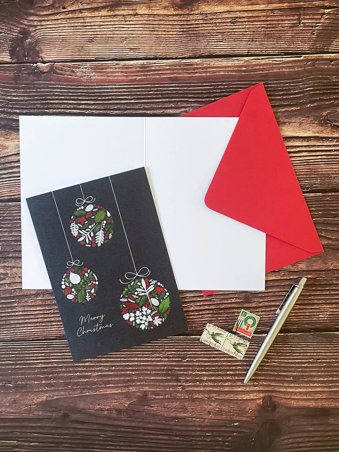 Christmas Card with Bauble Design on Open Card and Red Envelope - Blank Inside, Wood Background, Vintage Stamps, Silver Parker Pen