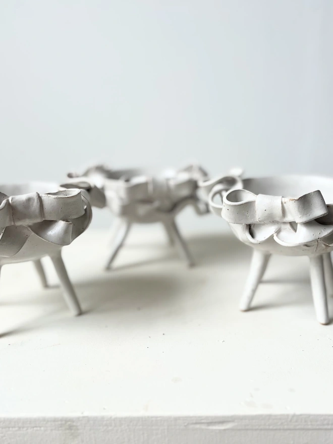 matt white bowls with flowing ceramic bows 