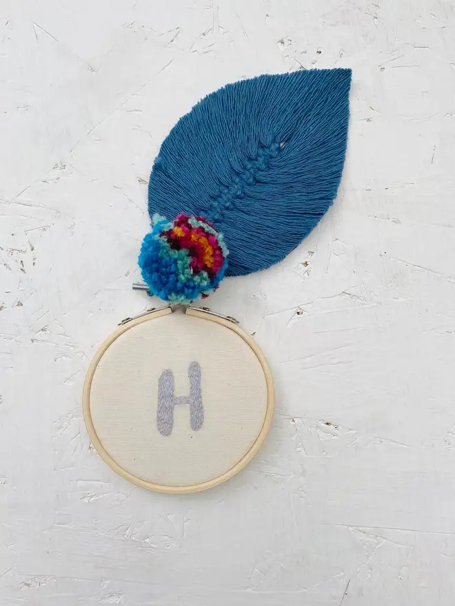 custom letter or number embroidered hoop. selection of cotton hoops embroidered with a blue letter H.