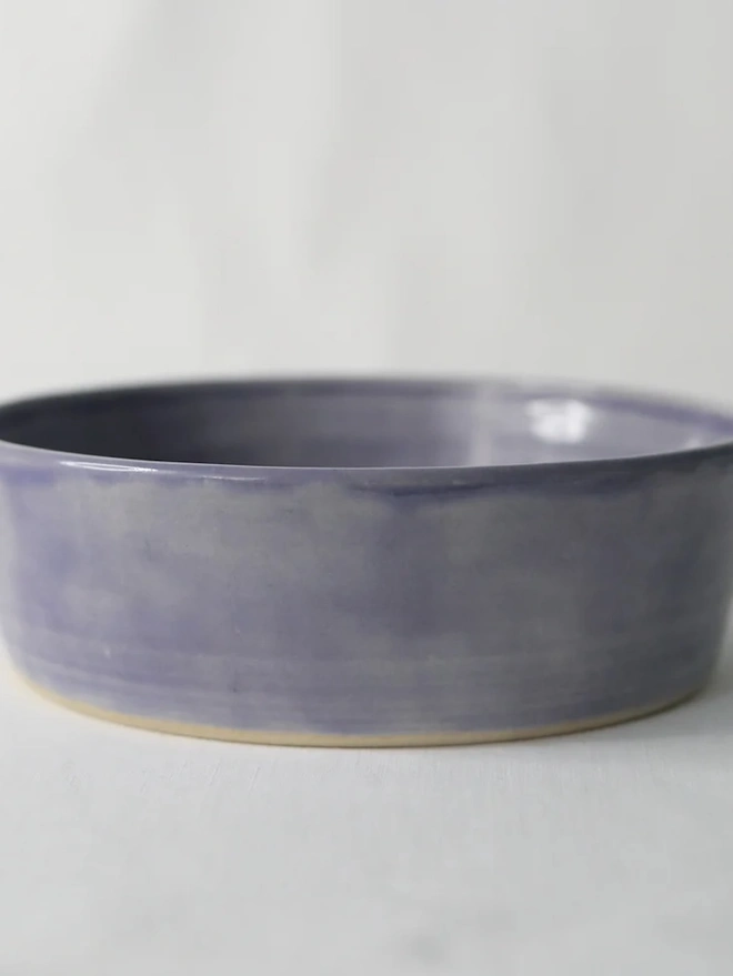 Classic Pasta Bowl, a colourful ceramic bowl sitting on a plain surface against a grey backdrop. 