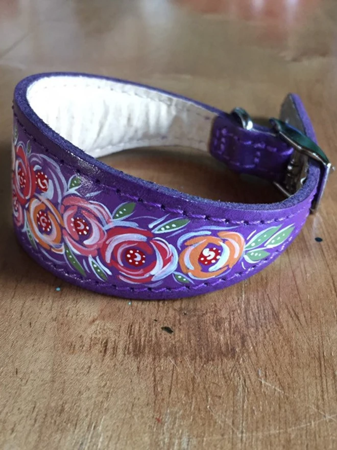 sleeping greyhound wearing purple floral hand painted leather collar