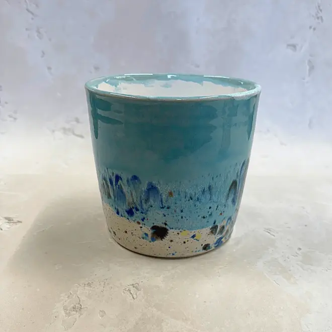 Shoreline Large Pot, a colourful pot placed on a stone surface. 