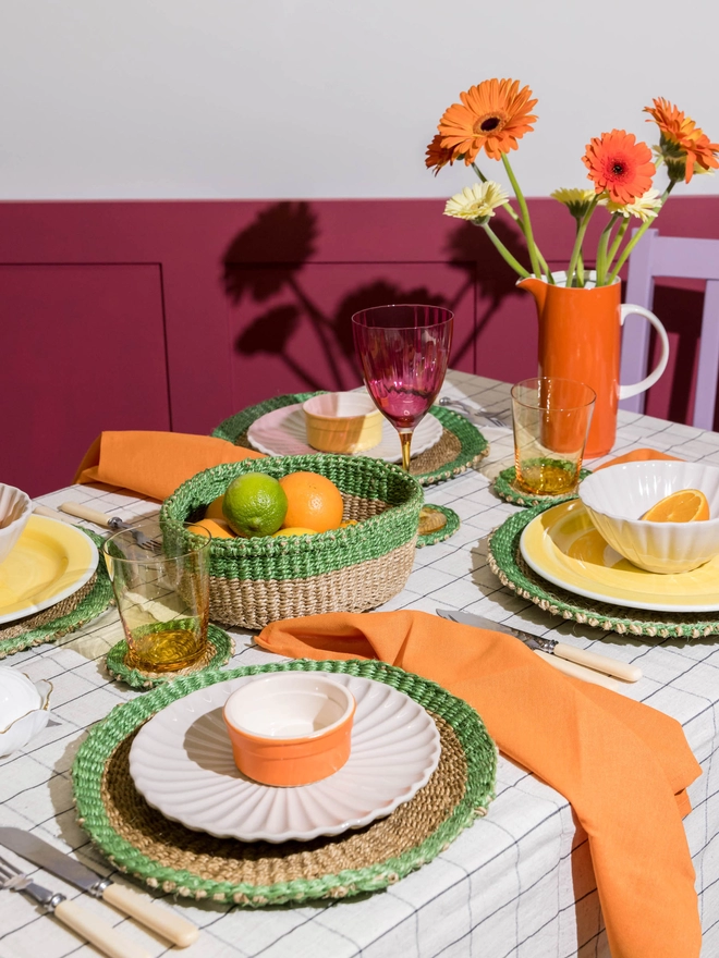 table set up using green and brown woven tableware